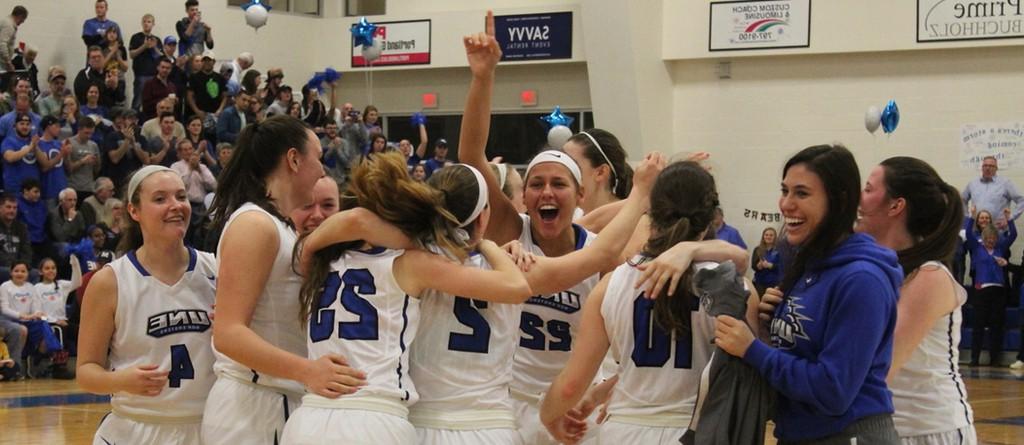 the women's basketball team celebrates a win on the court