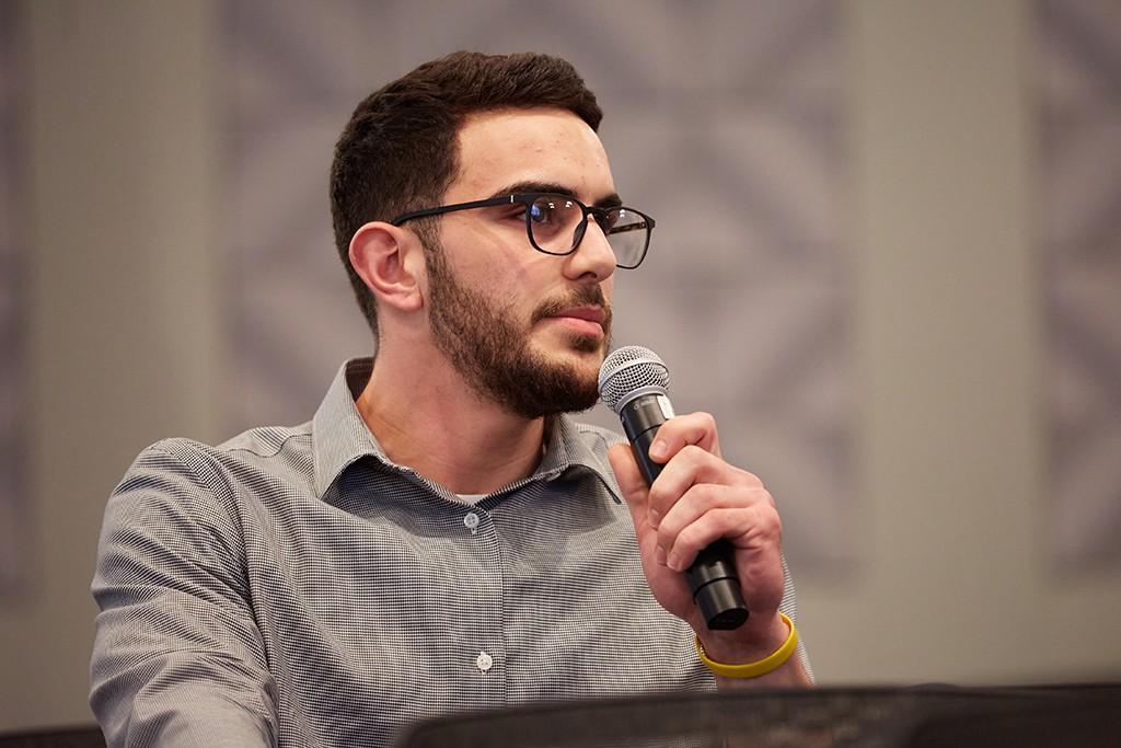 A student responding to a speaker at a lecture