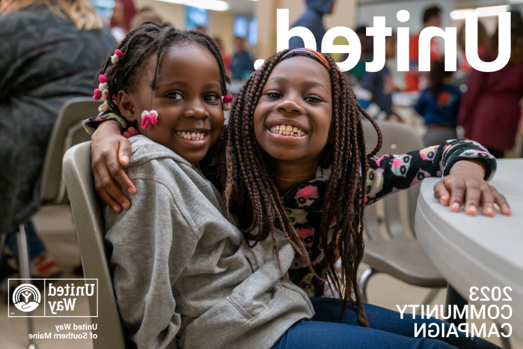 Two kids hug at a United Way event