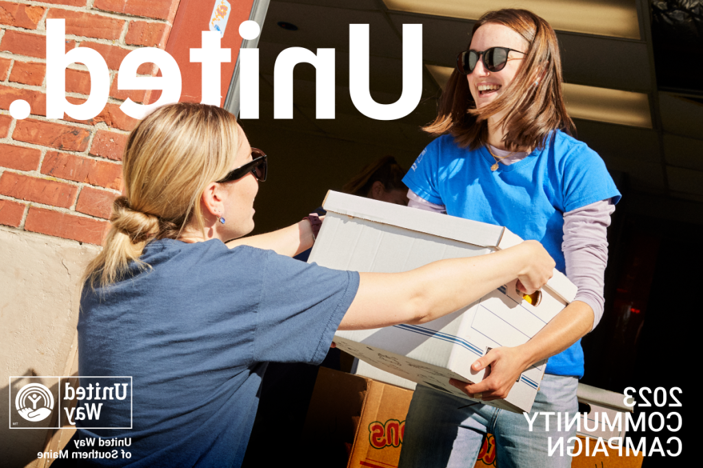 Two volunteers for United Way moving boxes