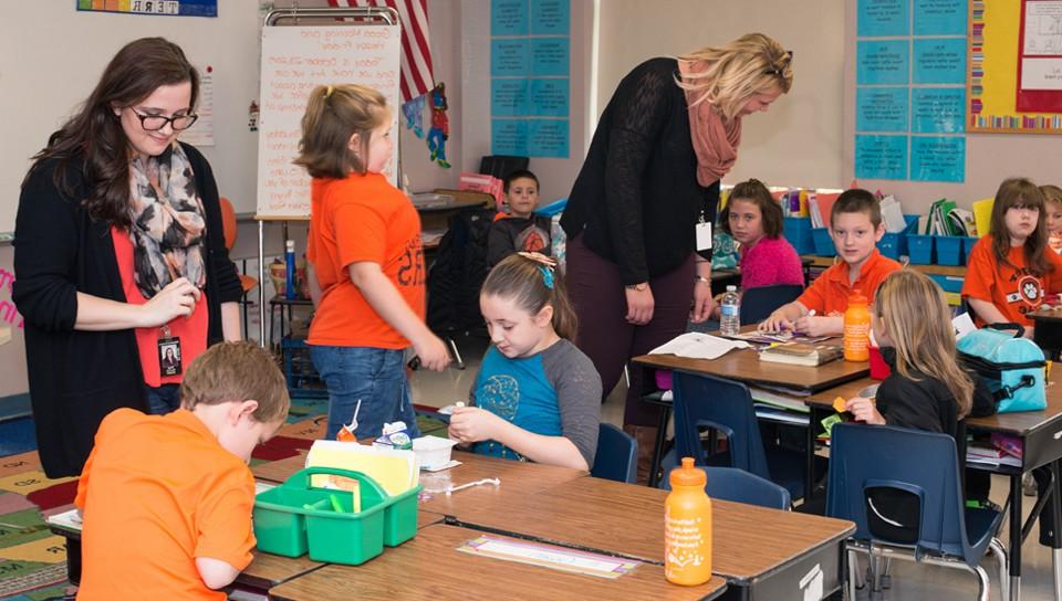 Two education majors working in an elementary school classroom