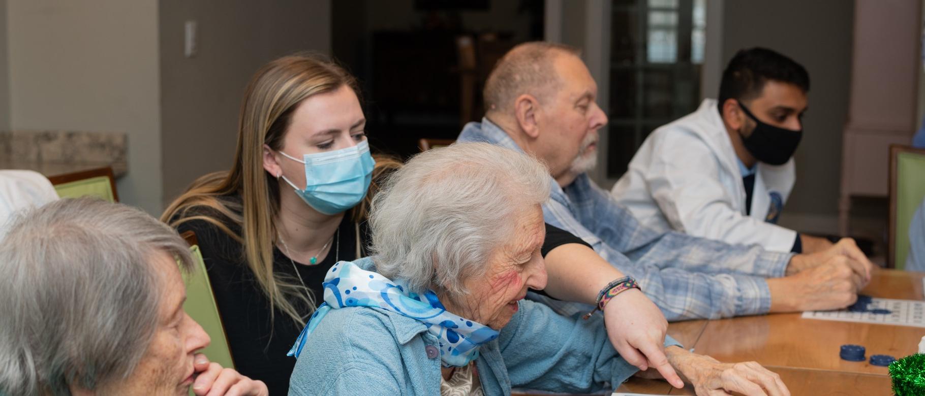 UNE health professions students play bingo with seniors at an assisted living facility