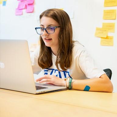 A student sits working on a lap top