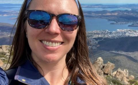 UNE professor Patricia Thibodeau poses with Hobart, Tasmania in the background